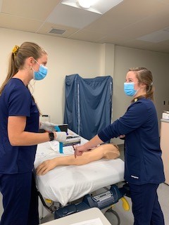 two nurses in a training simulation